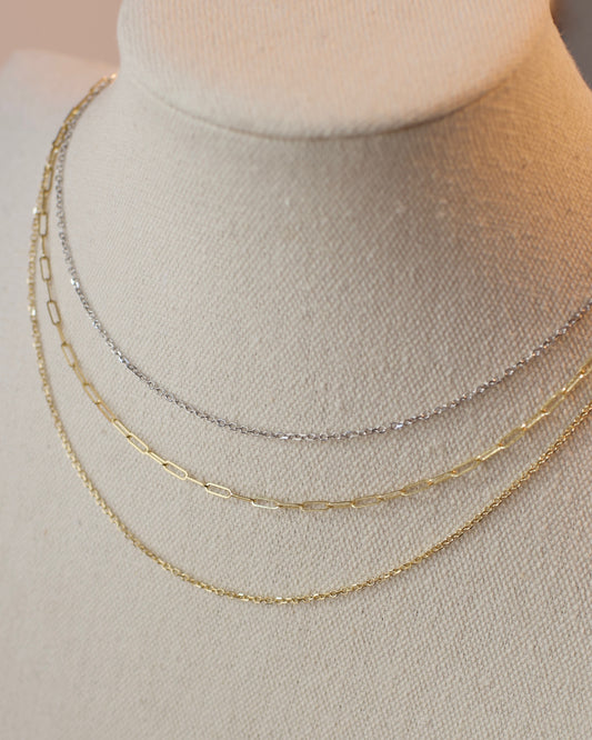 Three gold necklaces on a mannequin bust